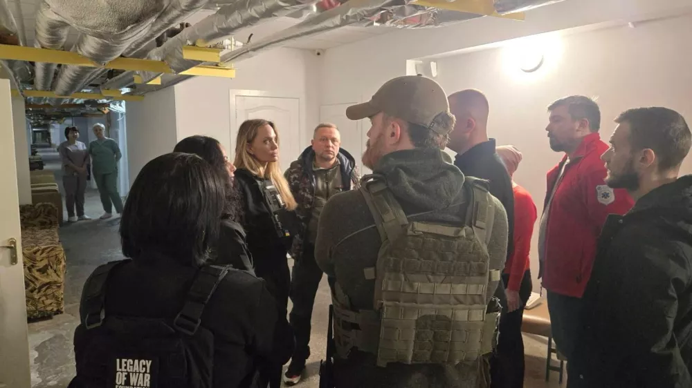 Angelina Jolie and others stand indoors with flak jackets on, in Kherson, Ukraine, in this handout image released on November 6, 2025. Legacy of War Foundation/Handout via REUTERS ATTENTION EDITORS - THIS IMAGE WAS PROVIDED BY A THIRD PARTY. MANDATORY CREDIT