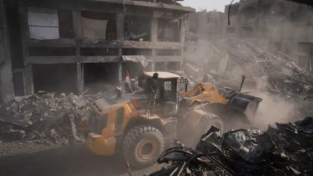 Hamas militants and Egyptian workers search for the bodies of Israeli hostages in the Shijaiyah neighborhood of Gaza City Wednesday, Nov. 5, 2025. (AP Photo/Jehad Alshrafi)