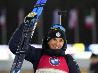 Julia Simon of France celebrates after winning the women's 10 km pursuit race at the Biathlon World Championship in Nove Mesto na Morave, Czech Republic, Sunday, Feb. 11, 2024. (AP Photo/Petr David Josek)