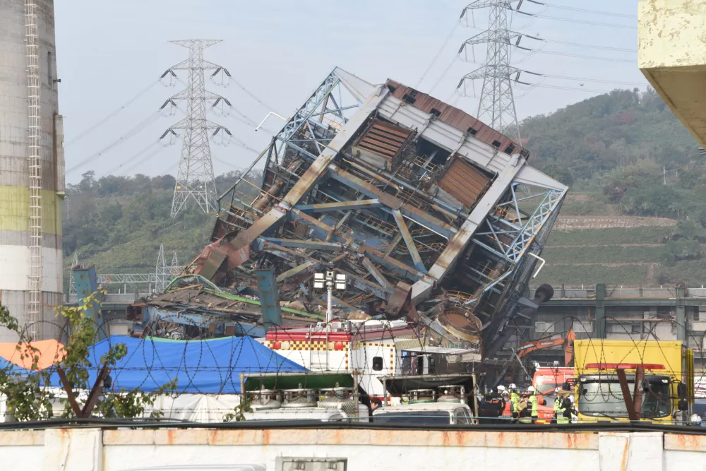 Rescue team work near a 60-meter (196-foot) tower which collapsed during demolition work at a decommissioned thermal power plant in Ulsan, South Korea, Friday, Nov. 7, 2025. (Bae Byung-soo/Newsis via AP)