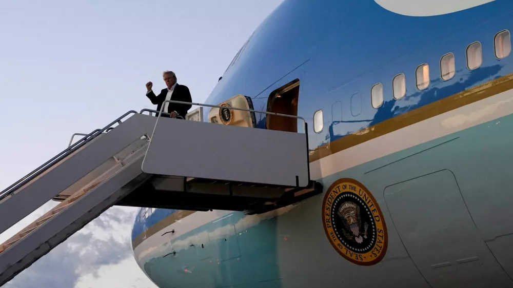 FILE PHOTO: U.S. President Donald Trump pumps a fist as he disembarks Air Force One at Palm Beach International Airport, West Palm Beach, Florida, U.S., April 11, 2025. REUTERS/Nathan Howard/File Photo