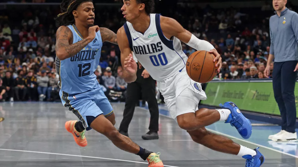 Nov 7, 2025; Memphis, Tennessee, USA; Dallas Mavericks guard Max Christie (00) drives to the basket against Memphis Grizzlies guard Ja Morant (12) during the fourth quarter at FedExForum. Mandatory Credit: Petre Thomas-Imagn Images