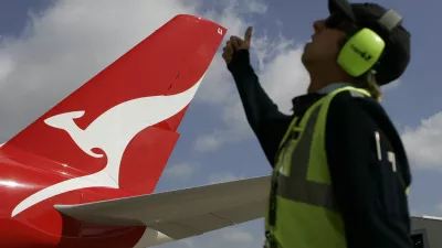 A worker gives his thumb up to a Qantas Airbus A380 as it arrives at a hangar after it landed at Kingsford Smith International Airport in Sydney September 21, 2008. Qantas took delivery of its first A380 superjumbo on Friday, two years later than planned due to production delays, and Airbus denied it planned another cut in its 2008 delivery forecast from the current 12 aircraft.  REUTERS/Daniel Munoz (AUSTRALIA) - RTX8R5U