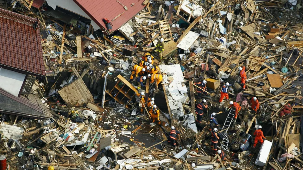 Rescuers searches for the victims of Friday's tsunami at Noda village, Iwate Prefecture, northern Japan, Monday, March 14, 2011, three days after a massive earthquake and the ensuing tsunami hit the country's east coast. (AP Photo/Kyodo News) JAPAN OUT, MANDATORY CREDIT, NO LICENSING IN CHINA, HONG KONG, JAPAN, SOUTH KOREA AND FRANCE