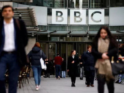 FILE PHOTO: Pedestrians walk past a BBC logo at Broadcasting House in London, Britain, January 29, 2020. REUTERS/Henry Nicholls/File Photo