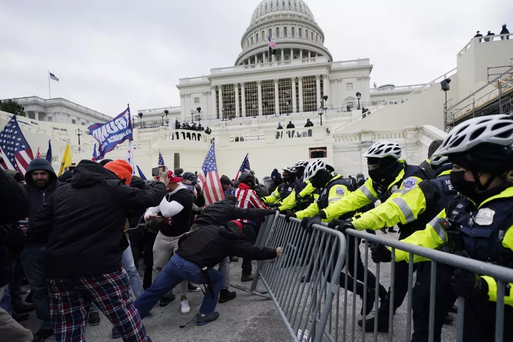 FILE - Violent insurrections loyal to President Donald Trump break through a police barrier at the Capitol in Washington. Over months,&nbsp;the House Select Committee investigating the Jan. 6 U.S. Capitol insurrection has issued more than 100 subpoenas, done more than 1,000 interviews and probed more than 100,000 documents to get to the bottom of the attack that day in 2021 by supporters of former President Donald Trump. (AP Photo/Julio Cortez, File)