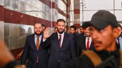 FILE - Syrian interim President Ahmad al-Sharaa waves as he enters a polling station where electoral college members are voting in a parliamentary election in Damascus, Syria, Oct. 5, 2025. (AP Photo/Omar Sanadiki, File)