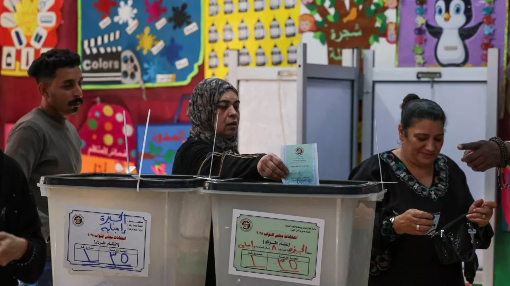 A woman votes at a school used as a polling station, during the first round of Egypt's parliamentary elections, in Giza, Egypt, November 10, 2025. REUTERS/Mohamed Abd El Ghany