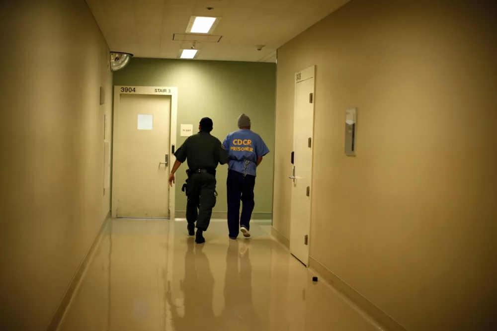 Albert Ruiz, 50, who is on death row for murder, is led down a corridor at San Quentin state prison in San Quentin, California in this June 8, 2012 file photo.The state hosts nearly a quarter of the nation's condemned prisoners but has executed none in the last six years. A federal judge halted all California executions in 2006, saying a three-drug lethal injection protocol risked causing inmates too much pain and suffering before death. California revised its protocol, but executions have not resumed. REUTERS/Lucy Nicholson/Files (UNITED STATES - Tags: CRIME LAW SOCIETY)