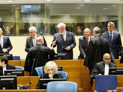 Back row from left: Bosnian Croats Jadranko Prlic, Bruno Stojic, Slobodan Praljak, Milivoj Petkovic, Valentin Coric and Berislav Pusic prior to their judgment at the Yugoslav war crimes tribunal (ICTY) in The Hague, Netherlands, Wednesday May 29, 2013. The ICTY delivers verdicts in the long-running trial of six senior Bosnian Croats on charges of crimes against Muslims and Serbs as they tried to carve out a Croat state in Bosnia during the country's 1992-95 war. Prosecutors have asked for sentences of up to 40 years for the suspects. (AP Photo/Jiri Buller, Pool)