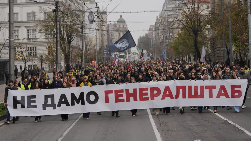 People hold a banner that reads: "We do not give army headquarters" during a protest in front of military complex that was partially destroyed in a NATO bombing campaign in 1999, after Serbian lawmakers on Friday passed a special law clearing the way for a controversial real estate project that would be financed by an investment company linked to President Trump's son-in-law Jared Kushner, in Belgrade, Serbia, Tuesday, Nov. 11, 2025. (AP Photo/Darko Vojinovic)