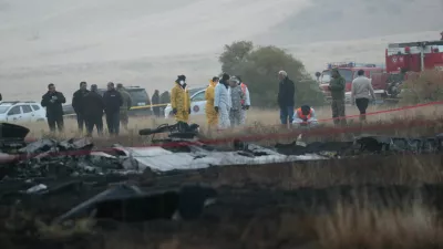 Members of emergency services work at the site of the Turkish C-130 military cargo plane crash near the Azerbaijani border, in Sighnaghi municipality, Georgia, November 12, 2025. REUTERS/Irakli Gedenidze