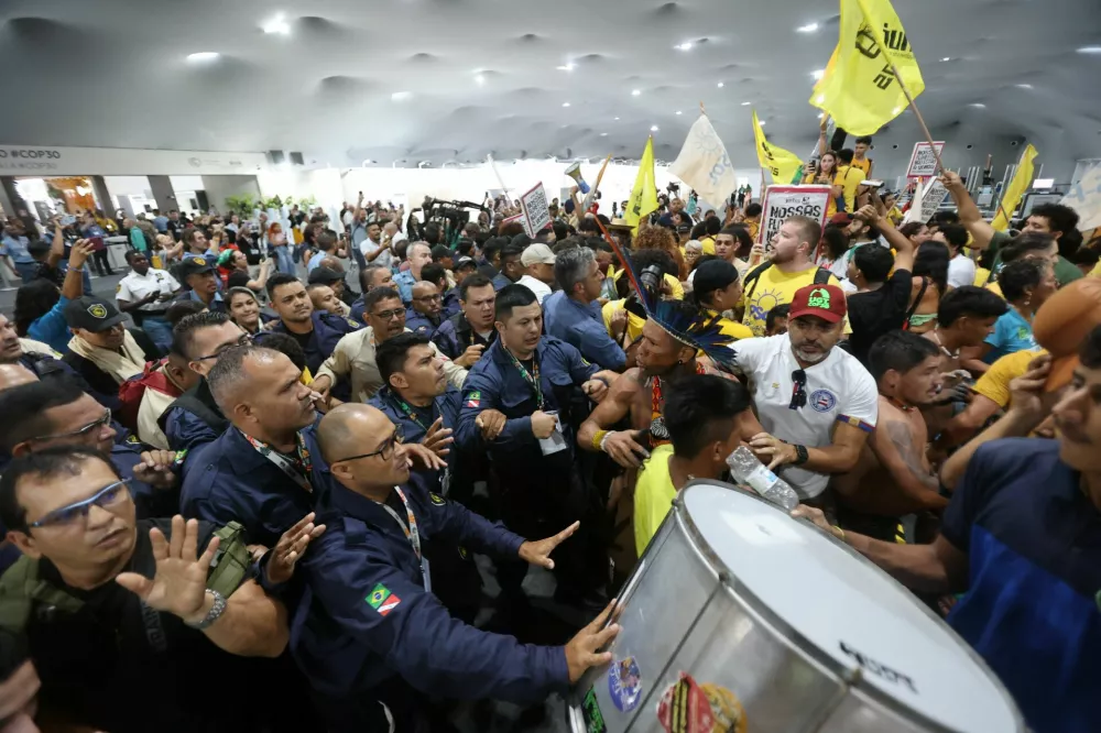 Demonstrators, including Indigenous people, take part in a protest as they force their way into the venue hosting the UN Climate Change Conference (COP30), in Belem, Brazil, November 11, 2025. REUTERS/Anderson Coelho