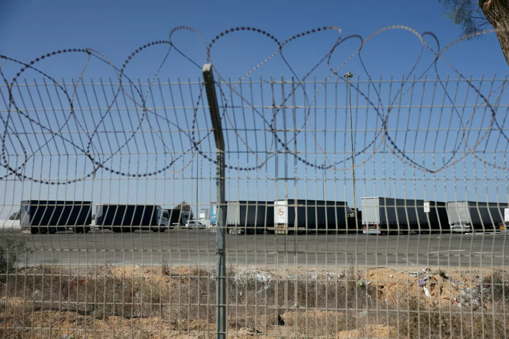 FILE PHOTO: Trucks carrying aid wait at the Israeli side of the Kerem Shalom border crossing to southern Gaza, amid a ceasefire deal between Israel and Hamas, in southern Israel, October 20, 2025. REUTERS/Hannah McKay/File Photo