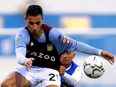 FILED - 24 August 2021, United Kingdom, Barrow-In-Furness: Then Aston Villa's Anwar El Ghazi (l) and Barrow's Connor Brown battle for the ball during the English Carabao Cup second round soccer match between Barrow and Aston Villa at Holker Street. Bundesliga football club Mainz has terminated its contract with Anwar El Ghazi following his pro-Palestinian posts on social media, the club said on Friday evening. Photo: Richard Sellers/PA Wire/dpa