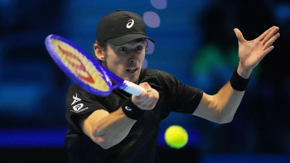 Australia's Alex de Minaur returns the ball to United States' Taylor Fritz during their tennis match of the ATP World Tour Finals, in Turin, Italy, Thursday, Nov. 13, 2025. (AP Photo/Antonio Calanni)