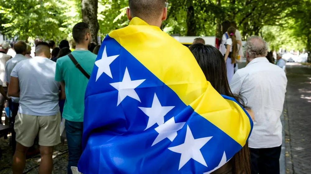 Attendees including one with a Bosnian flag take part in the National Commemoration of the Srebrenica Genocide in The Hague, on July 11, 2025. The commemoration commemorates the genocide that took place 30 years ago, of more than 8,000 Bosnian Muslim men in Srebrenica.,Image: 1021010293, License: Rights-managed, Restrictions: Netherlands OUT, Model Release: no