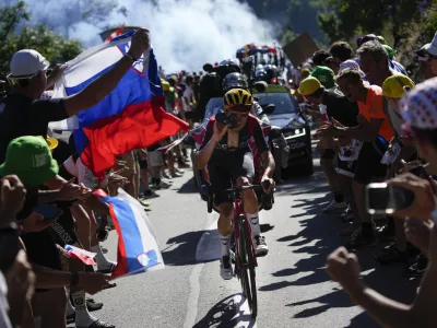 Stage winner Britain's Thomas Pidcock climbs Alpe D'Huez during the twelfth stage of the Tour de France cycling race over 165.5 kilometers (102.8 miles) with start in Briancon and finish in Alpe d'Huez, France, Thursday, July 14, 2022. (AP Photo/Daniel Cole)