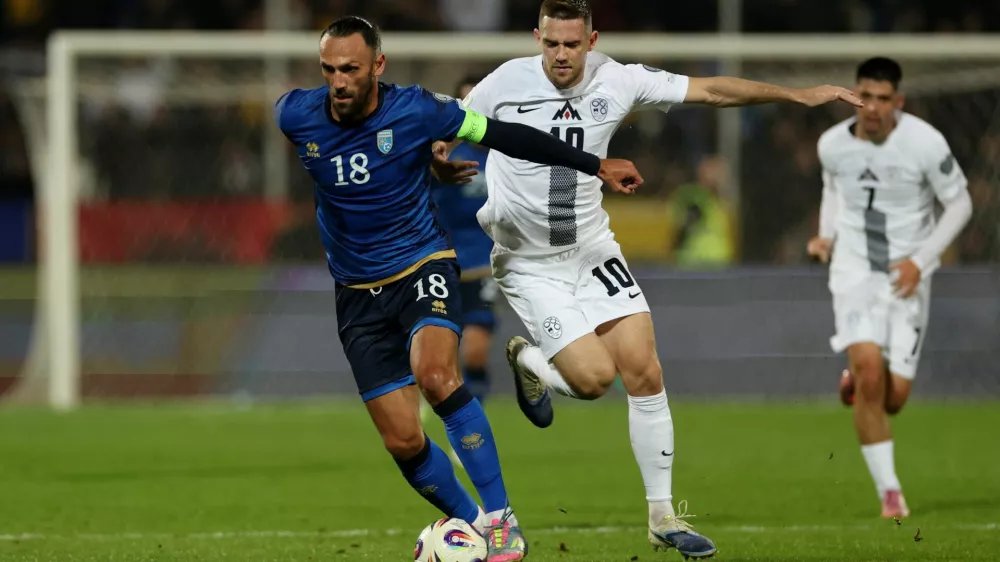 Soccer Football - FIFA World Cup - UEFA Qualifiers - Group B - Kosovo v Slovenia - Fadil Vokrri Stadium, Pristina, Kosovo - October 10, 2025 Kosovo's Vedat Muriqi in action with Slovenia's Timi Elsnik REUTERS/Valdrin Xhemaj