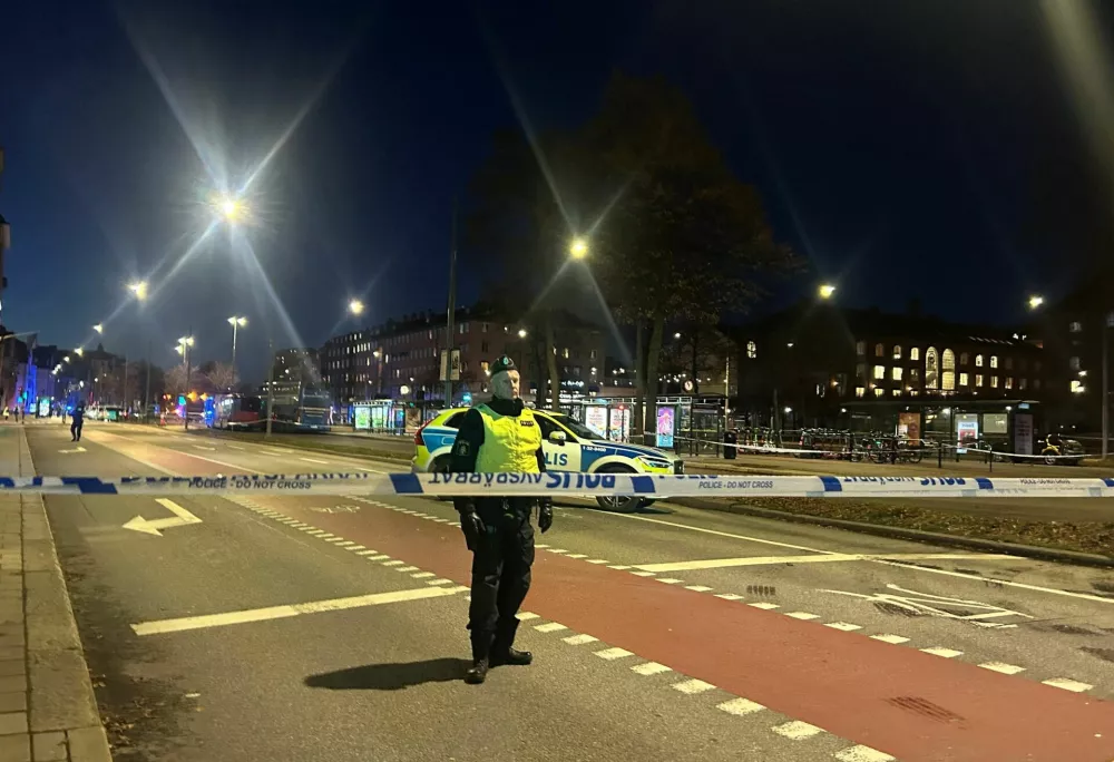 A Swedish police officer stands near the site where a bus hit a bus stop in central Stockholm, Sweden, November 14, 2025. REUTERS/Marie Mannes