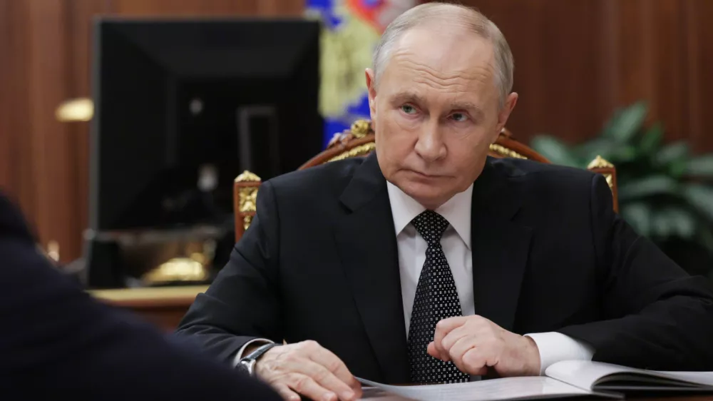 Russian President Vladimir Putin listens to Astrakhan Region Governor Igor Babushkin at the Kremlin in Moscow, Russia, Thursday, Nov. 13, 2025. (Gavriil Grigorov/Sputnik, Kremlin Pool Photo via AP)