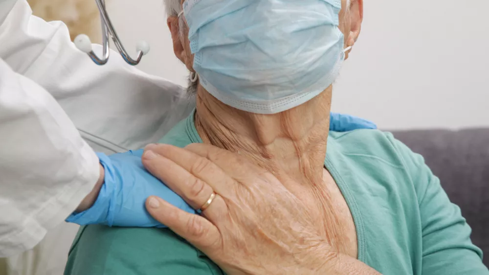 Portrait of elderly caucasian woman wearing protective medical mask. Care for the elderly people during corona virus outbreak, a helping hand, home care concept.