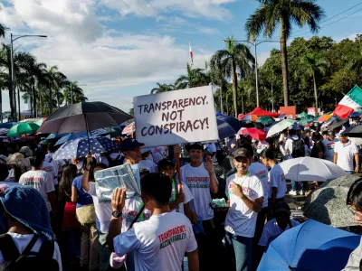 Members of the religious sect Iglesia Ni Cristo (Church of Christ) hold a placard as they participate in a three-day anti-corruption rally at Manila's Rizal Park, Philippines, Sunday, Nov. 16, 2025. (AP Photo/Mark Cristino)