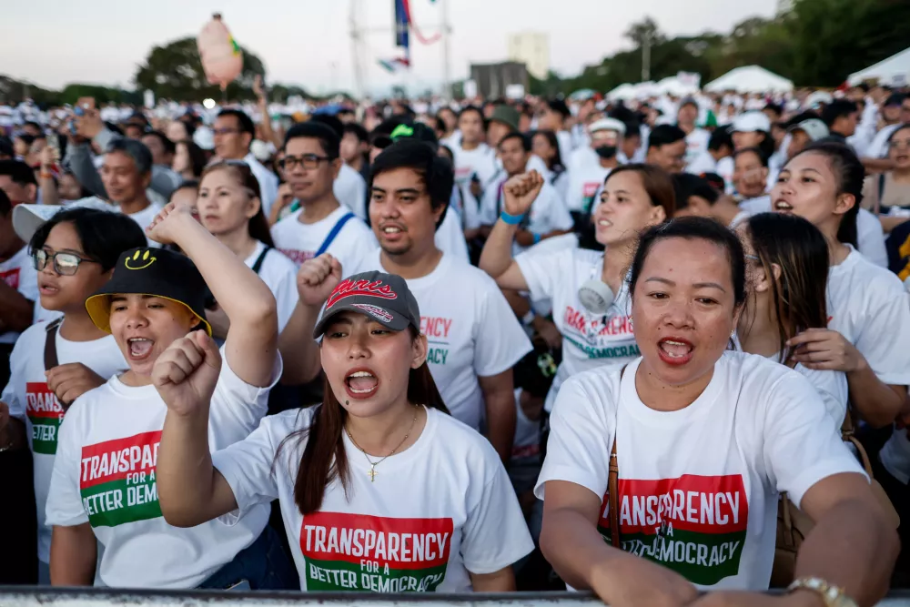 Members of the religious sect Iglesia Ni Cristo (Church of Christ) shout slogans during a three-day anti-corruption rally at Manila's Rizal Park, Philippines on Sunday, Nov. 16, 2025. (AP Photo/Mark Cristino)
