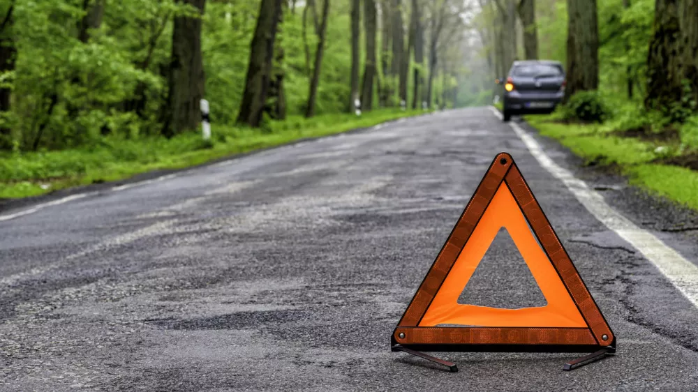 damaged car on a country road after a breakdown