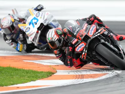 Italian rider Marco Bezzecchi of the Aprilia Racing, right, and Spain's rider Alex Marquez of the BK8 Gresini Racing MotoGP, left, compete during the Valencia Motorcycle MotoGP Grand Prix at the Ricardo Tormo circuit in Cheste, near Valencia, Spain, Sunday, Nov. 16, 2025. (AP Photo/Alberto Saiz)
