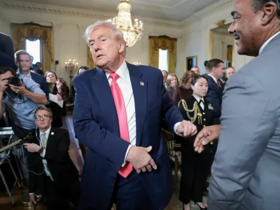 FILE PHOTO: U.S. President Donald Trump walks after shaking hands with Bruce LeVell following the signing of an executive order on "Fostering the Future" in the East Room of the White House, in Washington, D.C., U.S., November 13, 2025. REUTERS/Jonathan Ernst/File Photo