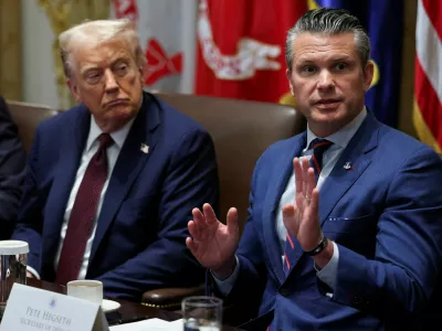FILE PHOTO: U.S. President Donald Trump and Defense Secretary Pete Hegseth attend a cabinet meeting at the White House in Washington, D.C., U.S., August 26, 2025. REUTERS/Jonathan Ernst/File Photo