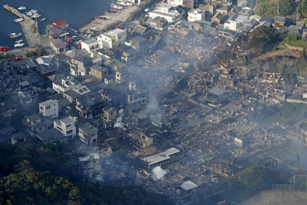 Smoke rises from a site where a massive fire blazed through more than 170 buildings, as seen from a helicopter, in Oita, Oita Prefecture, southwestern Japan, November 19, 2025, in this photo taken by Kyodo. Mandatory credit Kyodo/via REUTERS ATTENTION EDITORS - THIS IMAGE HAS BEEN SUPPLIED BY A THIRD PARTY. MANDATORY CREDIT. JAPAN OUT. NO COMMERCIAL OR EDITORIAL SALES IN JAPAN.