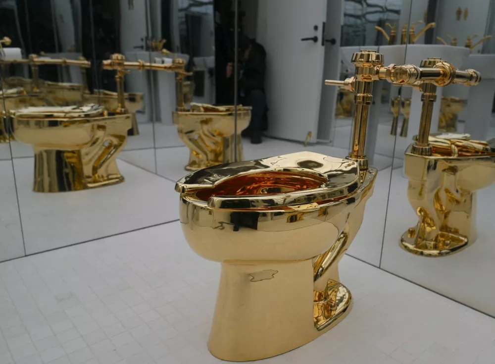 NEW YORK, UNITED STATES - NOVEMBER 17: Maurizio Cattelan's influential artwork, a solid gold toilet, 'America' (2016), is exhibited at the Breuer Building of Sotheby's in New York on November 17, 2025, in New York City, United States. Selcuk Acar / Anadolu/ABACAPRESS.COM,Image: 1052992503, License: Rights-managed, Restrictions:, Model Release: no