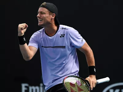 FILE - Australia's Lleyton Hewitt celebrates with compatriot John-Patrick Smith during their first round doubles match against New Zealand's Marcus Daniels and Wesly Koolhof of the Netherlands at the Australian Open tennis championships in Melbourne, Australia, Jan. 17, 2019. (AP Photo/Andy Brownbill, File)