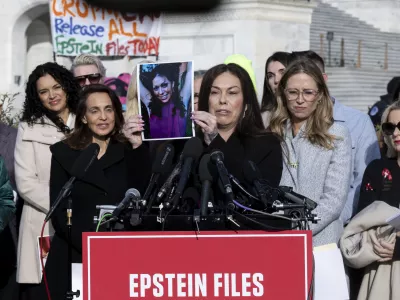 18 November 2025, US, WashingtonEpstein abuse survivor Haley Robson holds up a photo of her younger self during a news conference on the Epstein Files Transparency Act outside the US Capitol in Washington. PhotoMehmet Eser/ZUMA Press Wire/dpa