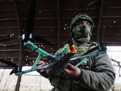 18 November 2025, Russia, ---: A member of a Russian Army 291st Regiment serviceman stands with a drone in the Zaporozhye sector of the frontline in the zone of the special military operation. Photo: Alexander Polegenko/TASS via ZUMA Press/dpa