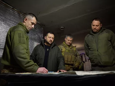 In this photo provided by the Ukrainian Presidential Press Office, Ukrainian President Volodymyr Zelenskyy, 2nd left, looks at a map during his visit to Ukrainian 110th mechanised brigade in Avdiivka, the site of fierce battles with the Russian troops in the Donetsk region, Ukraine, Friday, Dec. 29, 2023. Right is head of the Presidential Office Andriy Yermak; deputy head of the Presidential Office Roman Mashovets is 2nd right. (Ukrainian Presidential Press Office via AP)