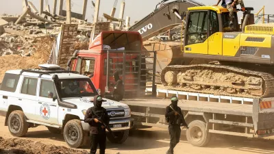 Hamas militants escort members of the Red Cross towards an area within the so-called "yellow line" to which Israeli troops withdrew under the ceasefire, as Hamas says it continues to search for the bodies of deceased hostages seized during the October 7, 2023, attack on Israel, in Gaza City November 20, 2025. REUTERS/Dawoud Abu Alkas