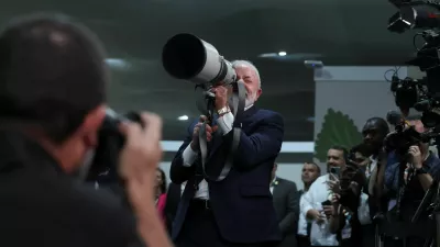 Brazil's President Luiz Inacio Lula da Silva holds a camera lens during the UN Climate Change Conference (COP30), in Belem, Brazil, November 19, 2025. REUTERS/Adriano Machado