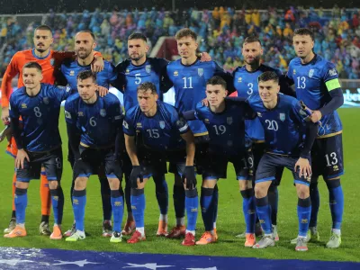 Kosovo starting players pose for a team photo at the beginning of the 2026 World Cup Group B qualifying soccer match between Kosovo and Switzerland in Pristina, Kosovo, Tuesday, Nov. 18, 2025. (AP Photo/Visar Kryeziu)