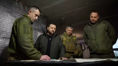In this photo provided by the Ukrainian Presidential Press Office, Ukrainian President Volodymyr Zelenskyy, 2nd left, looks at a map during his visit to Ukrainian 110th mechanised brigade in Avdiivka, the site of fierce battles with the Russian troops in the Donetsk region, Ukraine, Friday, Dec. 29, 2023. Right is head of the Presidential Office Andriy Yermak; deputy head of the Presidential Office Roman Mashovets is 2nd right. (Ukrainian Presidential Press Office via AP)