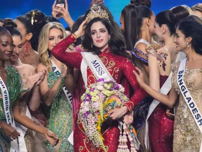 Miss Mexico Fatima Bosch, center, is celebrated by other contesters after winning the 2025 Miss Universe pageant in Nonthaburi, north of Bangkok, Thailand, Friday, Nov. 21, 2025. (AP Photo/Sakchai Lalit)