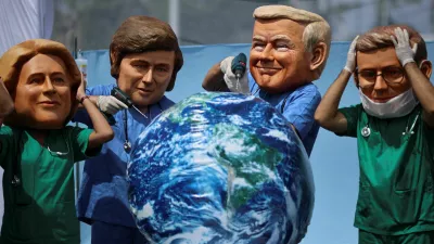 Oxfam activists wearing big head masks depicting world leaders stage a mock emergency room scene symbolizing a dying Planet Earth to call for urgent climate action during the UN Climate Change Conference (COP30), in Belem, Brazil, November 20, 2025. REUTERS/Adriano Machado   TPX IMAGES OF THE DAY