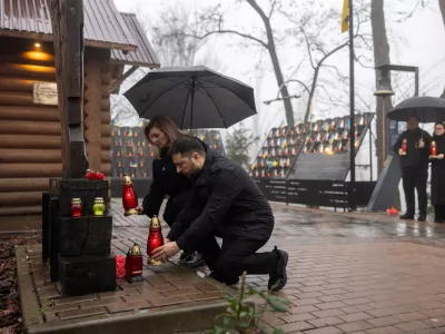 Ukraine's President Volodymyr Zelenskiy and his wife Olena attend a commemoration ceremony at a monument to the so-called "Heavenly Hundred", the people killed during the Ukrainian pro-European Union (EU) mass demonstrations in 2014, to mark the 12th anniversary of the start of the uprising, amid Russia's attack on Ukraine, in Kyiv, Ukraine November 21, 2025. Ukrainian Presidential Press Service/Handout via REUTERS ATTENTION EDITORS - THIS IMAGE HAS BEEN SUPPLIED BY A THIRD PARTY.