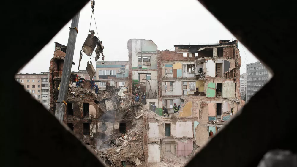 Rescue workers clear the rubble of a residential building which was heavily damaged by a Russian strike on Ternopil, Ukraine, Friday, Nov. 21, 2025. (AP Photo/Vlad Kravchuk)