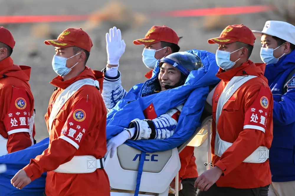 In this photo released by Xinhua News Agency, Chen Zhongrui, a Shenzhou-20 astronaut, is carried out from the Shenzhou-21 spaceship's return capsule after it touched down on Earth at the Dongfeng landing site in northern China's Inner Mongolia Autonomous region on Friday, Nov. 14, 2025. (Li Zhipeng/Xinhua via AP)