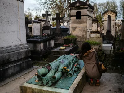 A woman touches the Recumbent Effigy of French journalist Victor Noir, who was shot and killed by Prince Pierre Bonaparte, a cousin of the French Emperor Napoleon III in 1870, at the Pere-Lachaise cemetery in Paris on November 10, 2024.,Image: 933070151, License: Rights-managed, Restrictions:, Model Release: no