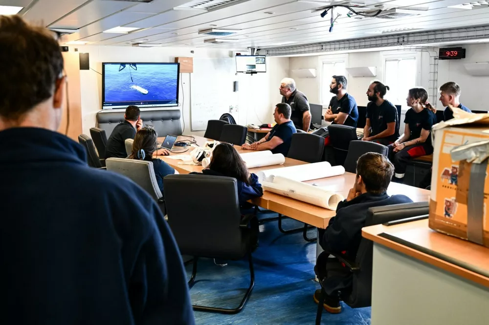 Scientists and technicians hold an briefing meeting aboard the scientific ship ATALANTE docked at the port of Brest before its departure, in Brest, western France, on June 15, 2025. Between 1950 and 1990, more than 200,000 barrels filled with radioactive waste were thrown into the abyss of the Northeast Atlantic Ocean. The first mission of the NODSSUM campaign, planned from June 15 to July 11, 2025 and led by the French National Centre for Scientific Research (CNRS), aims to map the main barrel immersion area and study interactions with marine biodiversity.,Image: 1011220229, License: Rights-managed, Restrictions:, Model Release: no