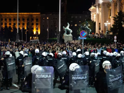 Serbian riot police separate rival crowds of opponents and loyalists of autocratic President Aleksandar Vucic, a day after tens of thousands of people joined a huge rally in the northern city of Novi Sad marking the first anniversary of a train station disaster there that killed 16 people, in Belgrade, Serbia, Sunday, Nov. 2, 2025. (AP Photo/Marko Drobnjakovic)